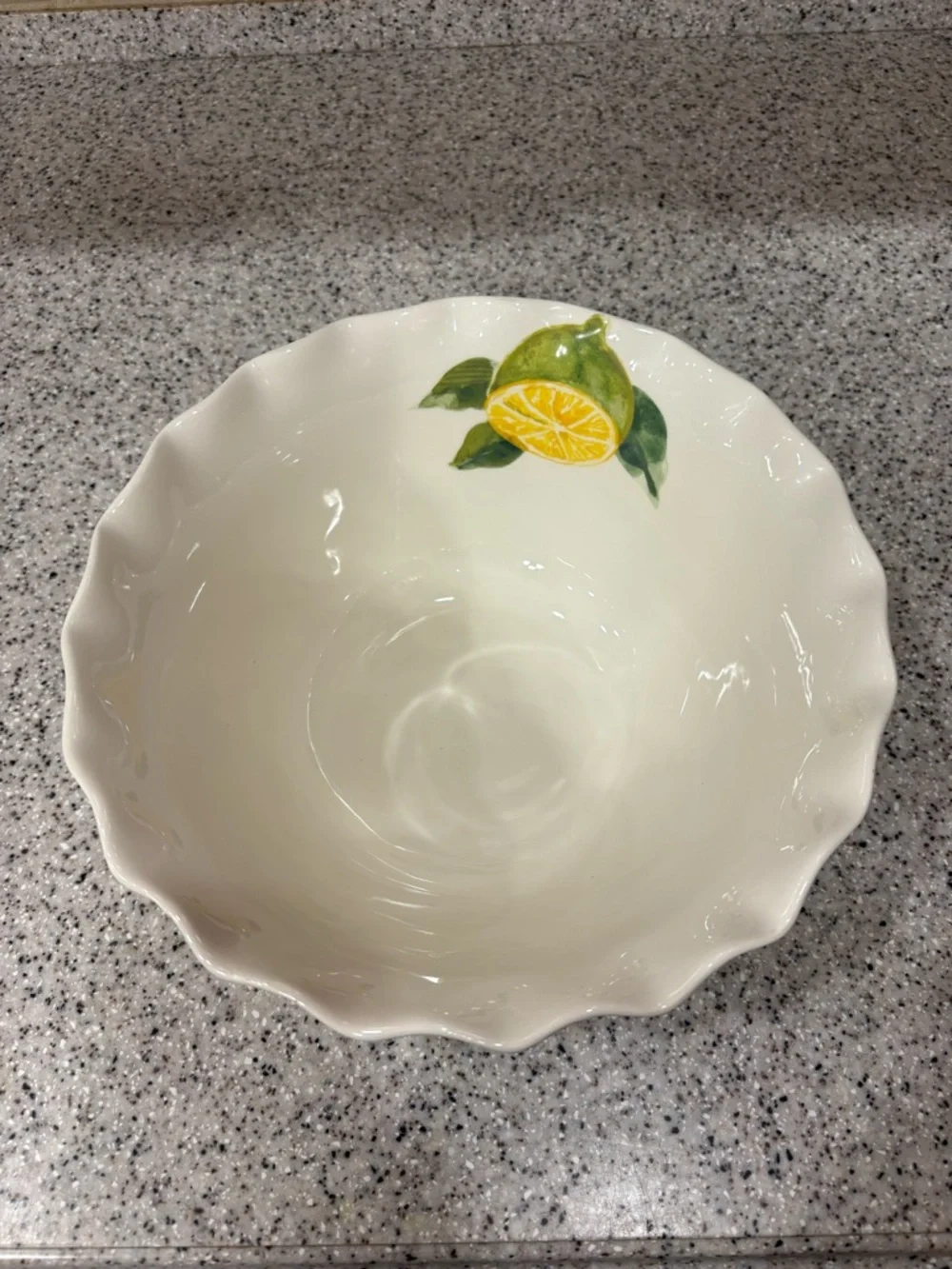 Hand-painted ceramic ruffle bowl featuring lemon motifs. Never Used. Display